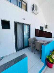 a patio with a table and chairs in a building at Vila Francesko in Ksamil