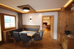 a dining room with a table and chairs at Haus Dorfblick in Gerlos