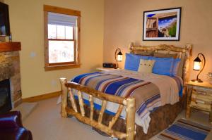 a bedroom with a wooden bed and a fireplace at Niwot Inn & Spa in Niwot