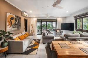 a living room with couches and a table at NEW Beachfront 3-bedrooms Apartment in Tamarin, Ocean Legend in Tamarin