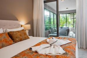 a bedroom with a bed with two pillows on it at NEW Beachfront 3-bedrooms Apartment in Tamarin, Ocean Legend in Tamarin +68 photos