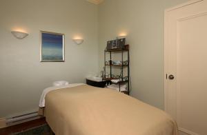 
a bedroom with a bed, desk, and bookshelf at Sir Sam's Inn & Spa in Haliburton
