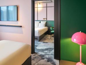 a hotel room with a mirror and a bed and a room at TRIBE Lyon Croix Rousse in Lyon +111 photos