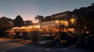a large building with lights in front of it at Hotel Restaurante Playa de Estorde in Cee +17 photos