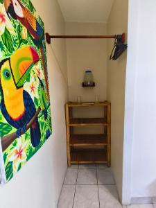 a painting of a parrot hanging on a wall at Chale's House Hotel in San Juan del Sur