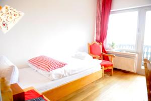 a bedroom with a bed and a chair and a window at BELVEDERE - das BIO HOTEL Garni & SuiteHotel am Edersee ! Unser Geschenk für Sie, auch die GästeCard GrimmHeimat! in Waldeck +71 photos