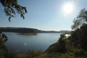 a view of a lake with the sun in the sky at BELVEDERE - das BIO HOTEL Garni & SuiteHotel am Edersee ! Unser Geschenk für Sie, auch die GästeCard GrimmHeimat! in Waldeck