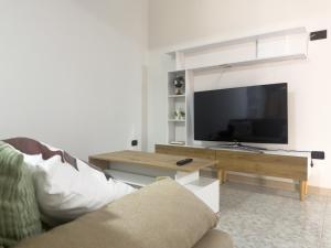 a living room with a tv and a couch at Unit 120 in SantʼAgata di Militello