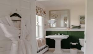 a bathroom with a sink and a toilet and a mirror at Mountain View Grand Resort & Spa in Whitefield