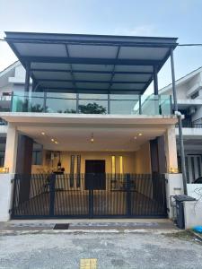 a house with a large glass window on top of it at Suzys homestay in Kuantan