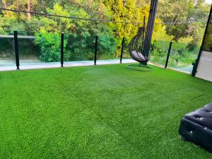 a green lawn with a hammock in the middle at Suzys homestay in Kuantan