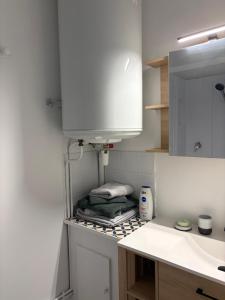 a kitchen with a sink and a counter with towels at L'Envol in Tillé