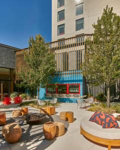 a courtyard with benches and trees and a building at Virgin Hotels Dallas in Dallas