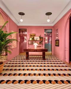 a room with pink walls and a table in the middle at Virgin Hotels New Orleans in New Orleans +238 photos