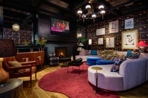 a living room with two couches and a fireplace at Virgin Hotels New Orleans in New Orleans
