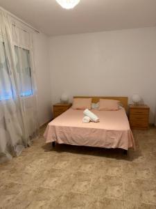 a bedroom with a bed with two towels on it at Apartments Figueres in Figueres