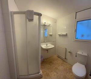 a bathroom with a shower and a toilet and a sink at Apartments Figueres in Figueres +20 photos
