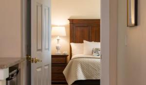 a bedroom with a bed and a lamp on a night stand at Mountain View Grand Resort & Spa in Whitefield