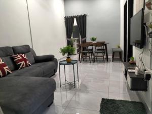 a living room with a couch and a table at 910 Entire Homestay Seremban Town, Templer, Lobak, Lekas Highway in Seremban