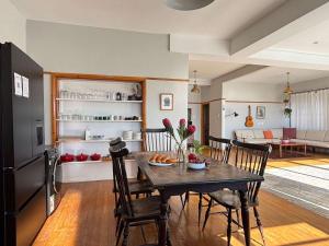 a kitchen and dining room with a table and chairs at Beach Paradise in Muizenberg