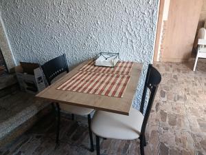 a wooden table with chairs and a box on top at A casa do sal 