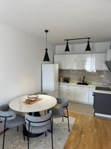 a kitchen with a table and chairs in a room at Lovely apartmant Bar in Bar +5 photos