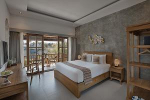 a bedroom with a bed and a balcony at Villa Mirah Ubud in Ubud +123 photos