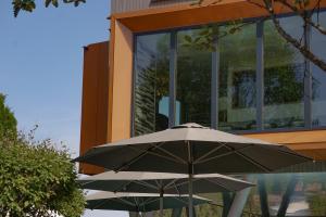 a black umbrella sitting in front of a building at Parkhotel Flora am Schluchsee in Schluchsee