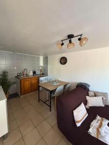 a living room with a couch and a table at L'Envol in Tillé +20 photos