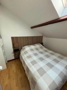 a bedroom with a large bed in a attic at L'Envol in Tillé