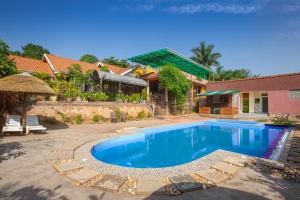 a swimming pool in a yard with a house at Dream jet suites in Entebbe