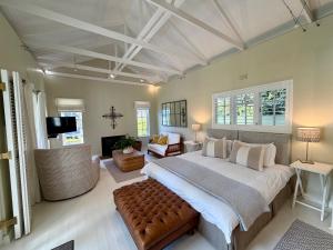 a bedroom with a large bed and a living room at Chambery in Cape Town +32 photos