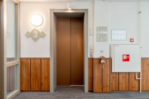 a hallway with a brown door in a building at BizStay Harbour I Scheveningen Apartments in Scheveningen