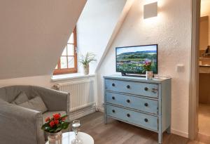 a living room with a tv on top of a dresser at Zur Schleikate in Boren +6 photos