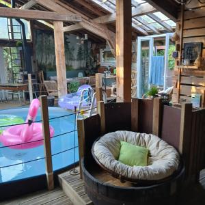 a room with two chairs and a swimming pool at Gîte l'Atelier Bois in Gaillères