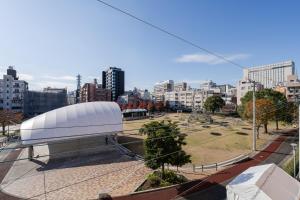 a large white building on top of a city at fleuve tenmonkan in Yamashitachō