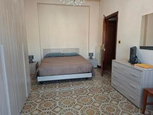 a bedroom with a bed and a dresser and a television at la casa di LILLY con wi fi in Avellino