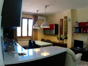 a kitchen and living room with a table and chairs at Locazione Turistica Spaccarotella Vista su Gualdo Cattaneo in Gualdo Cattaneo +47 photos