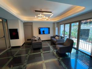 a living room with two couches and a tv at Hotel Lina Oldcity in Istanbul