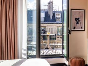 a room with a view of a balcony at Hotel Maison Hamelin Paris - Handwritten Collection in Paris +61 photos
