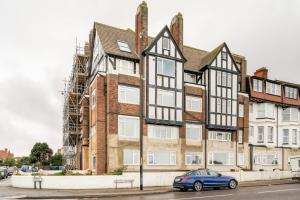 a blue car parked in front of a building at Walpole Bay Sea Views in Margate