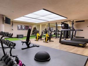 a gym with treadmills and ellipticals in a room at Novotel Valencia Lavant in Valencia +120 photos