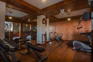 a gym with several exercise bikes and a brick wall at BB Angkor Residence in Siem Reap