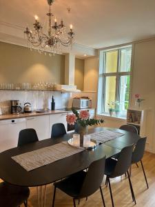 a kitchen with a table and chairs and a dining room at Lodge Visnes Stryn in Stryn