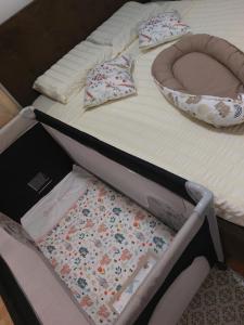 a bed with pillows sitting on top of it at VukaNest apartman Jagodina in Jagodina +3 photos