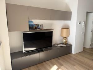a living room with a large flat screen tv at Casa Vacanze Regina in Lecco