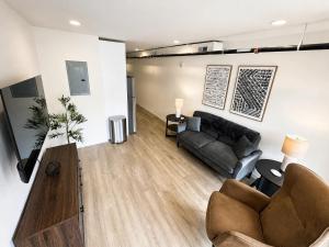 a living room with a couch and a table at The Accessible Atom | Historic Main in St. Charles