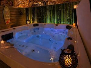 a jacuzzi tub in a room with a vase at La biche au bois piscine chauffee jacuzzi in Cazals +48 photos