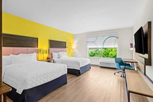 a hotel room with two beds and a television at Tru By Hilton Princeton in Princeton +25 photos