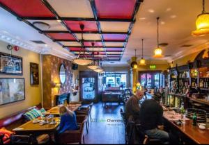 a group of people sitting at a bar in a restaurant at Horans Bar and Restaurant in Baltinglass